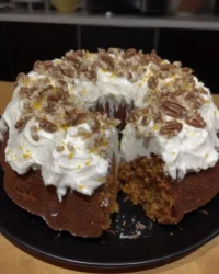Slice of carrot cake showing moist crumb and cream cheese frosting layers