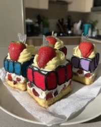 Slice of cartoon cake with black buttercream outlines and pink frosting