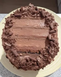 Slice of pink champagne New Year cake with blue drip