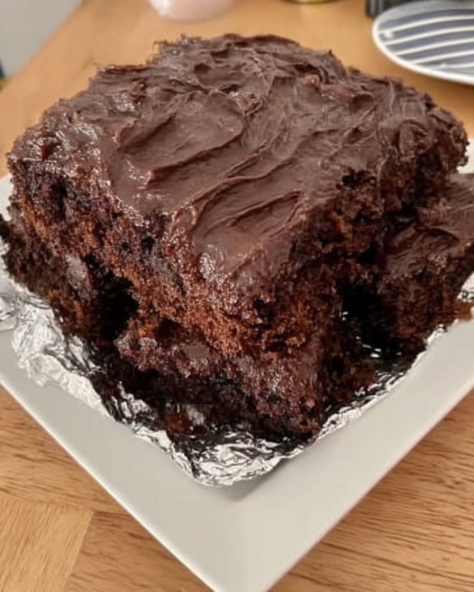 Square of wacky cake dusted with powdered sugar