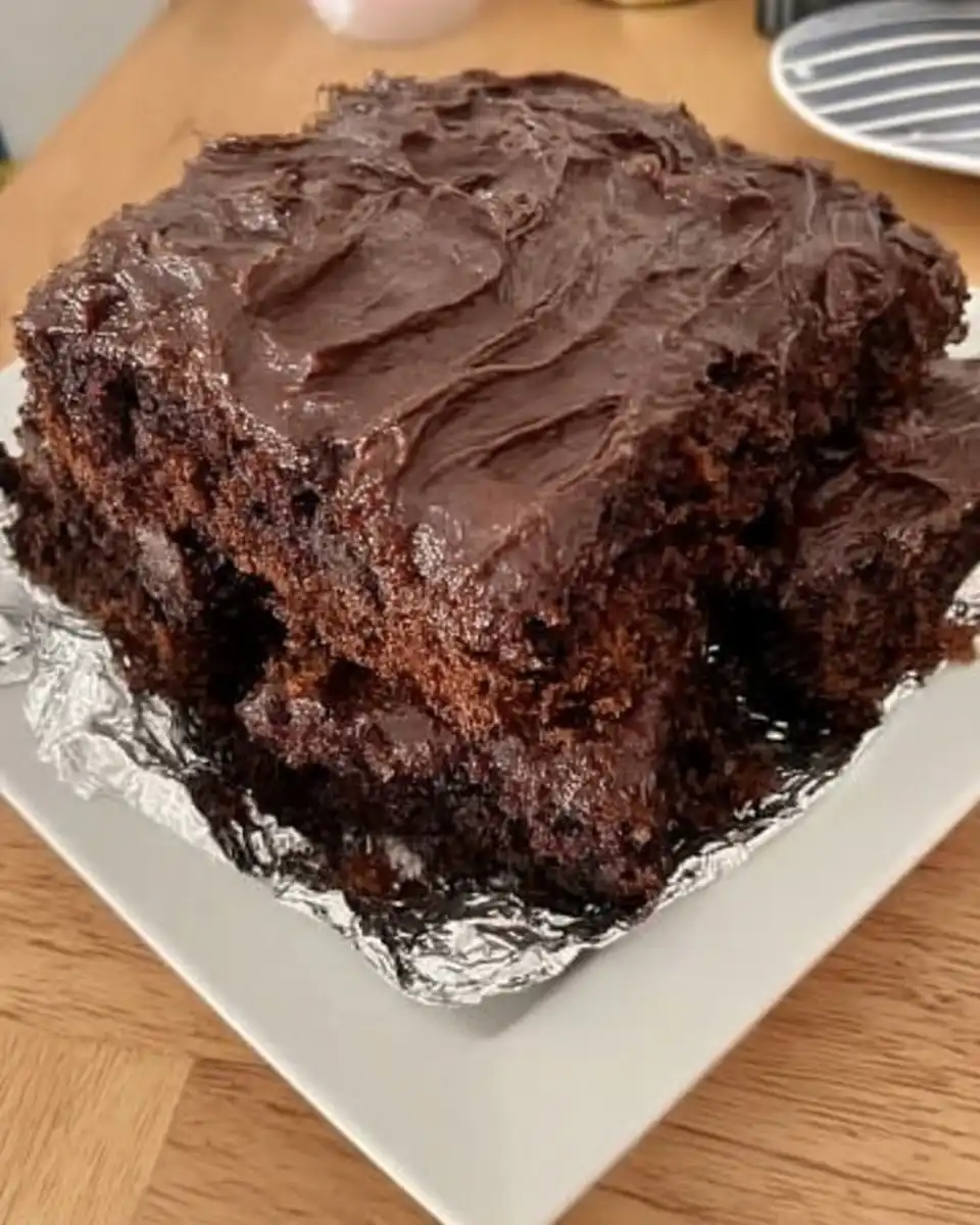 Square of wacky cake dusted with powdered sugar