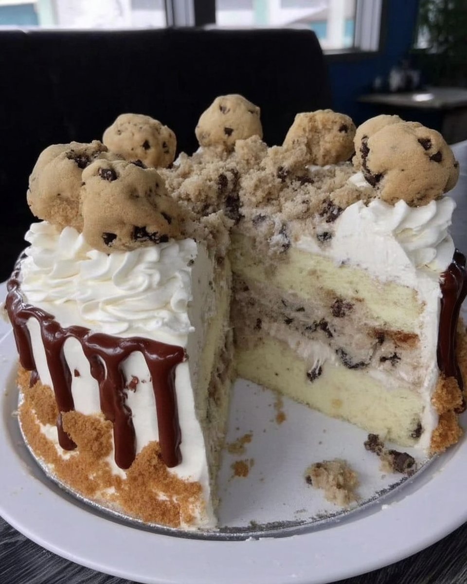 Slice of cookies and cream cake showing dark chocolate layers and speckled oreo buttercream