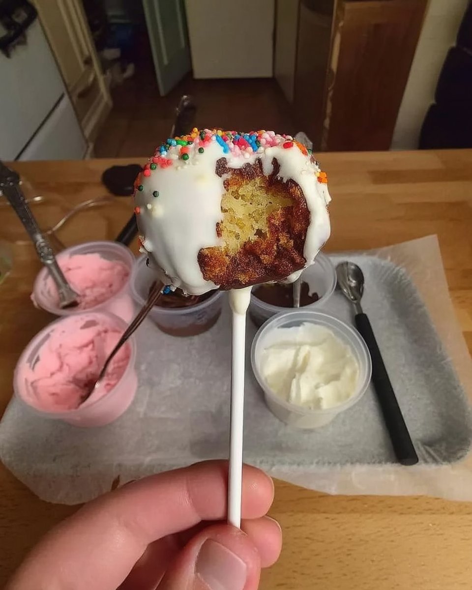 Dipping cheesecake balls into melted white chocolate