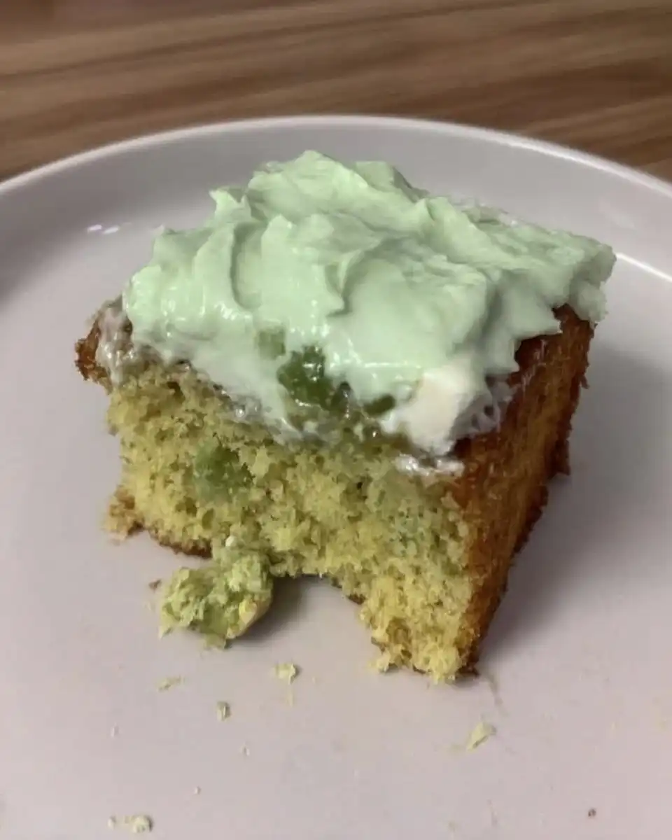 Whisking pistachio pudding into whipped topping for watergate cake frosting