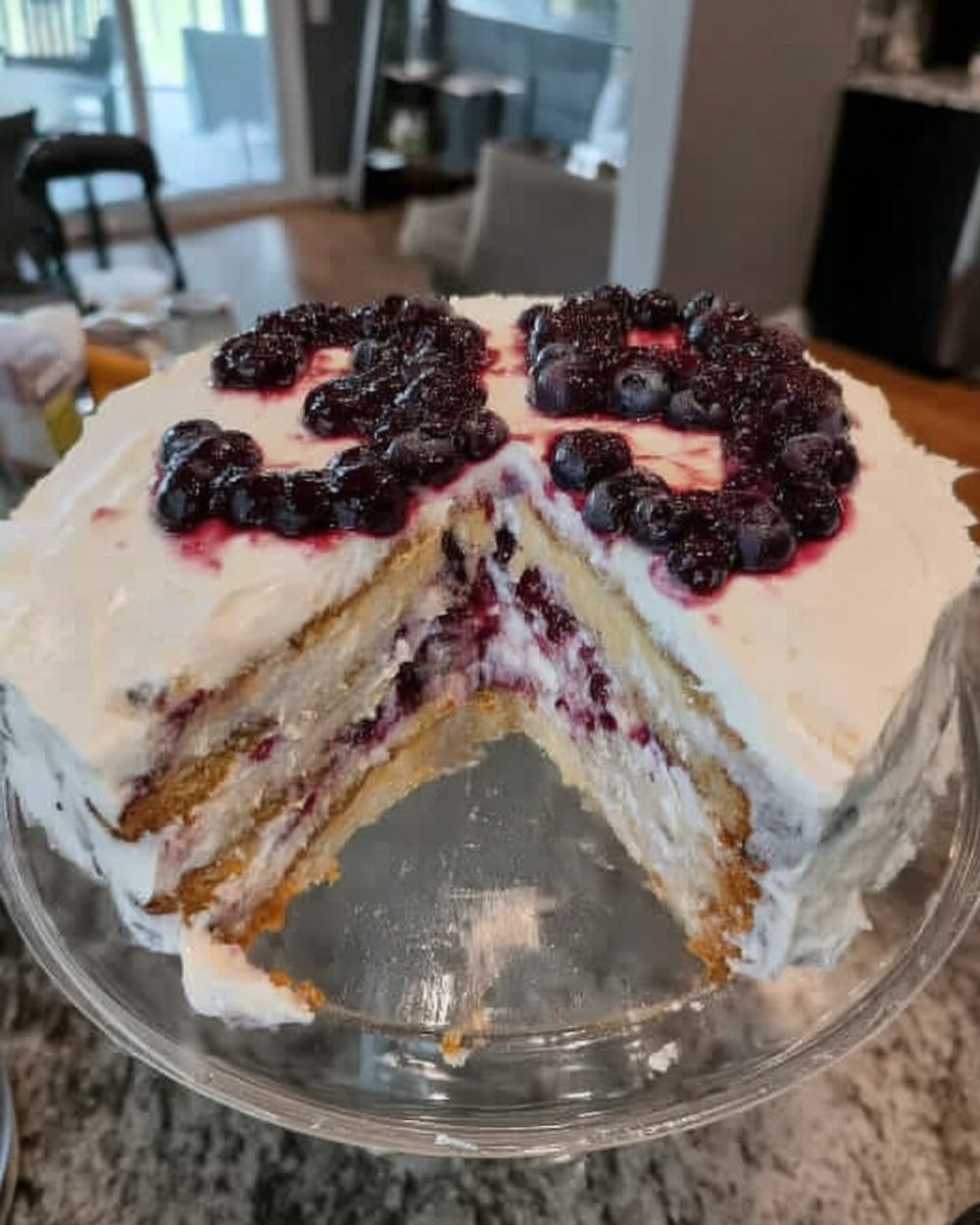 Folding flour-coated blueberries into the cake batter