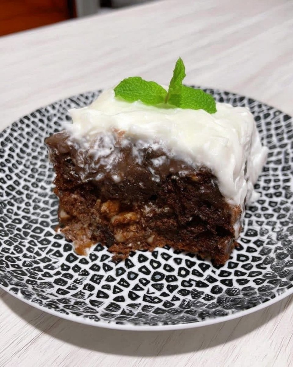 Whole frosted tomato soup cake on a ceramic stand