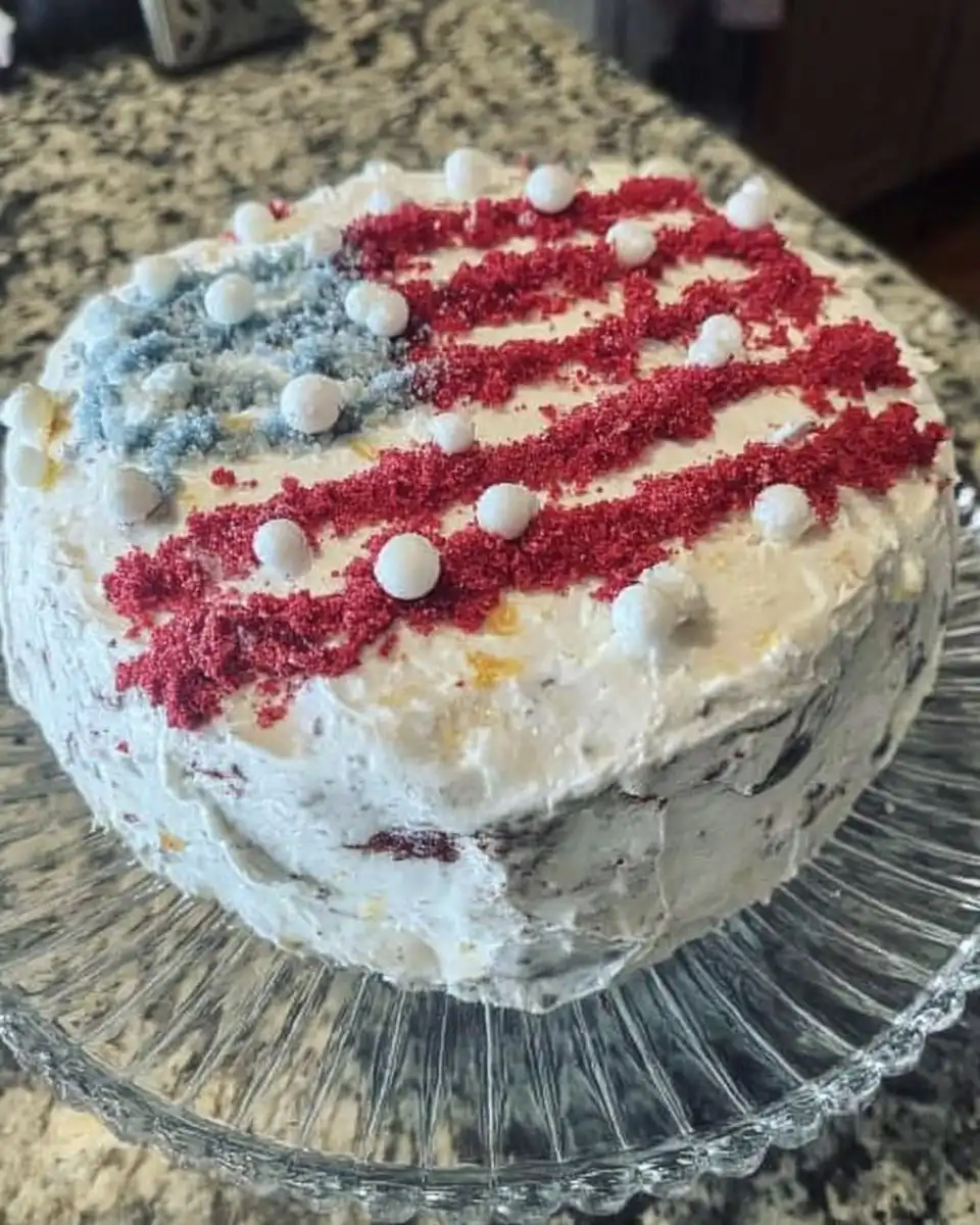 Ingredients for red white and blue cake including yellow cake mix berries and whipped topping
