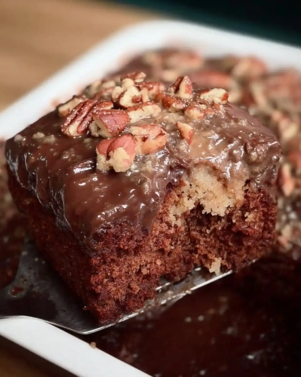 Old Fashioned Chocolate Cake 10 Slice of old fashioned chocolate cake with pecan icing on a ceramic plate