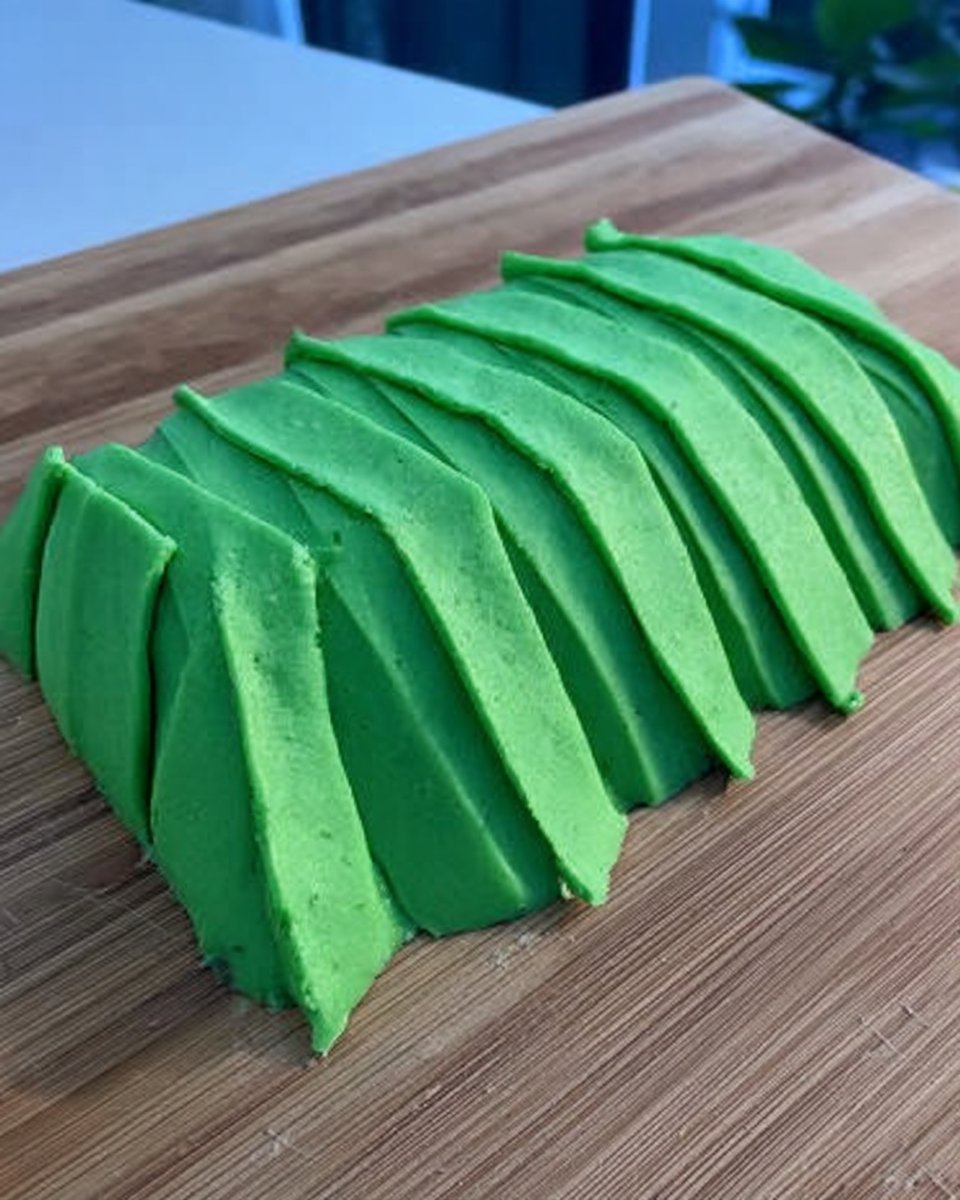 Whipped cream being mixed with orange food coloring