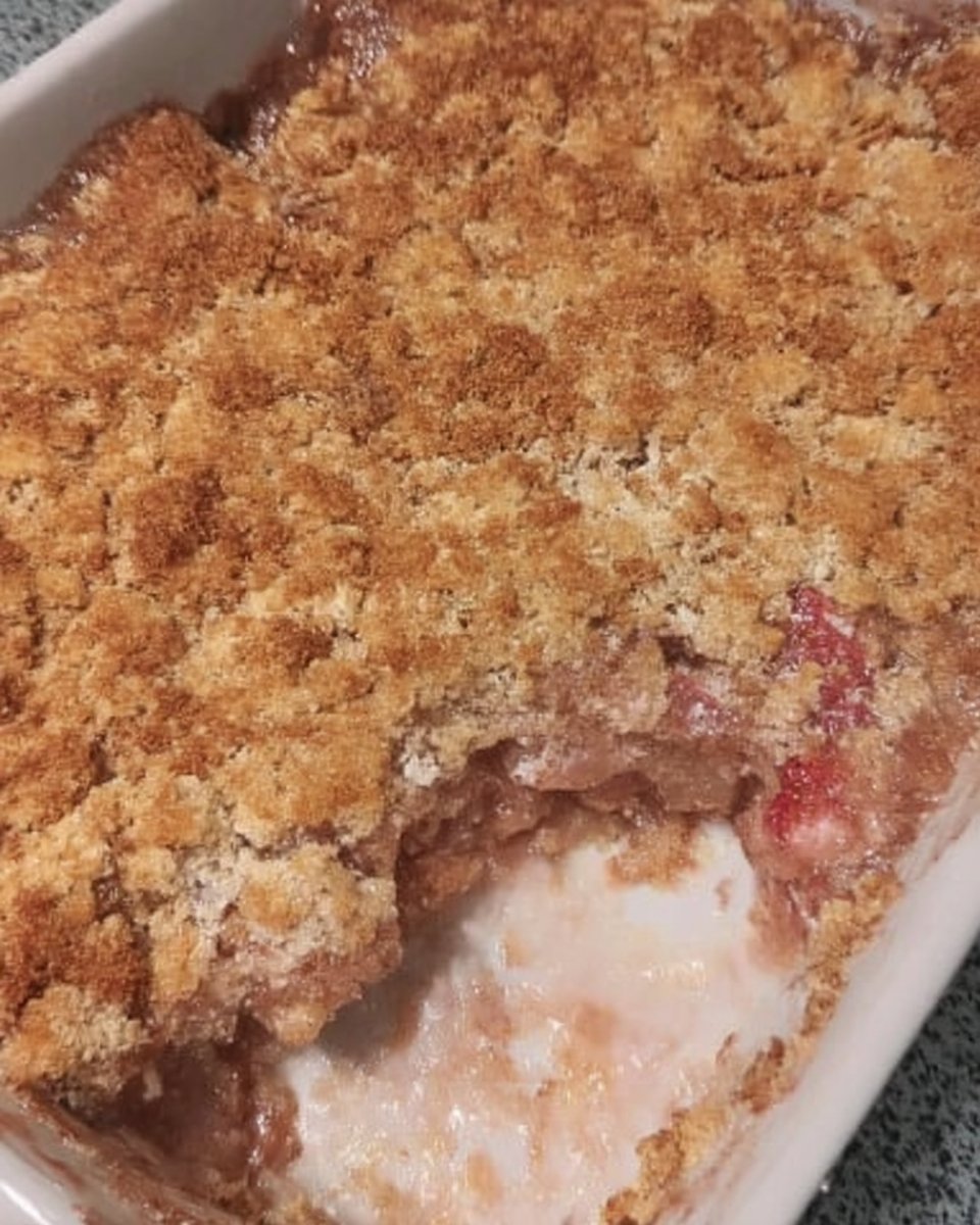 Wooden skewer poking holes in baked fruit cake