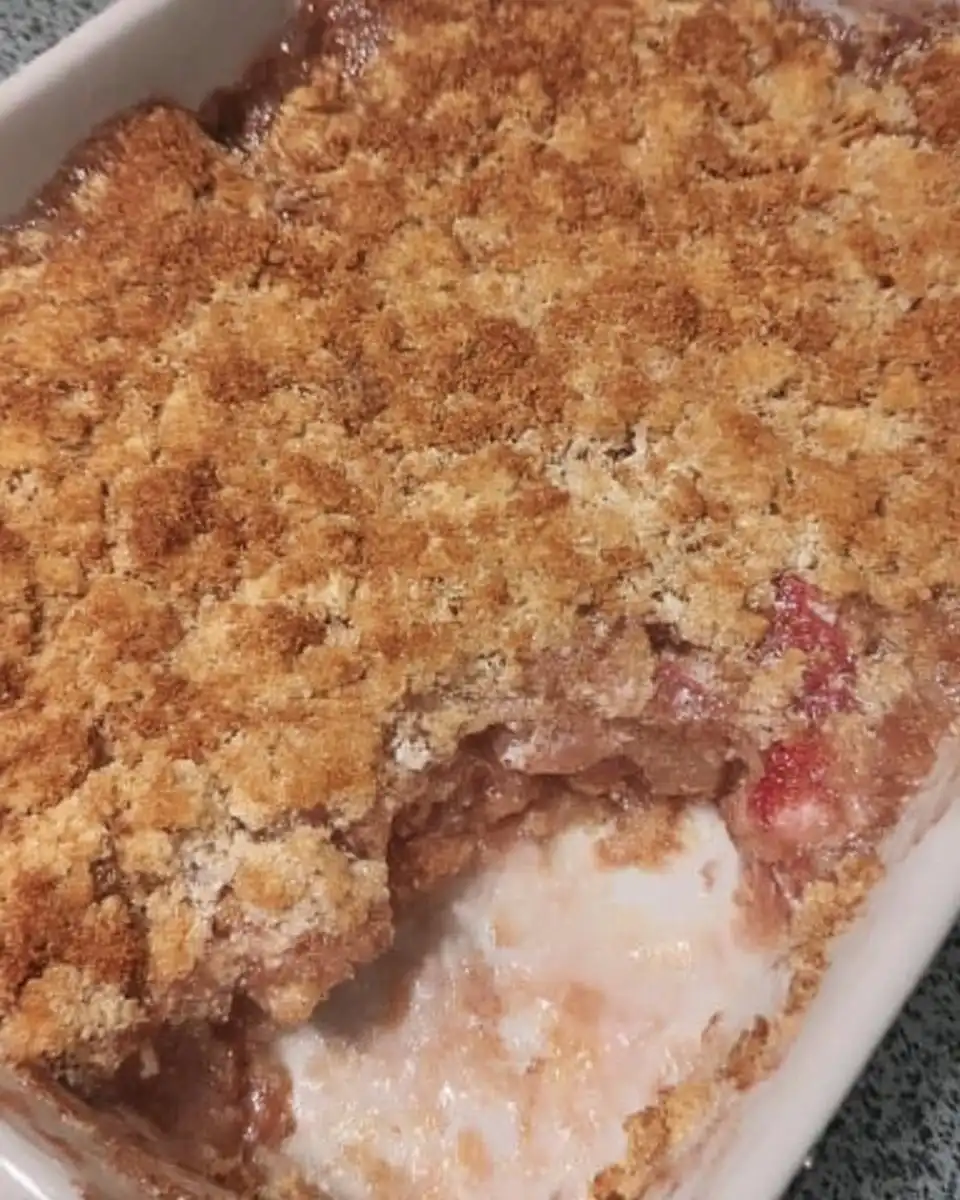 Strawberry Rhubarb Cake 13 Wooden skewer poking holes in baked fruit cake