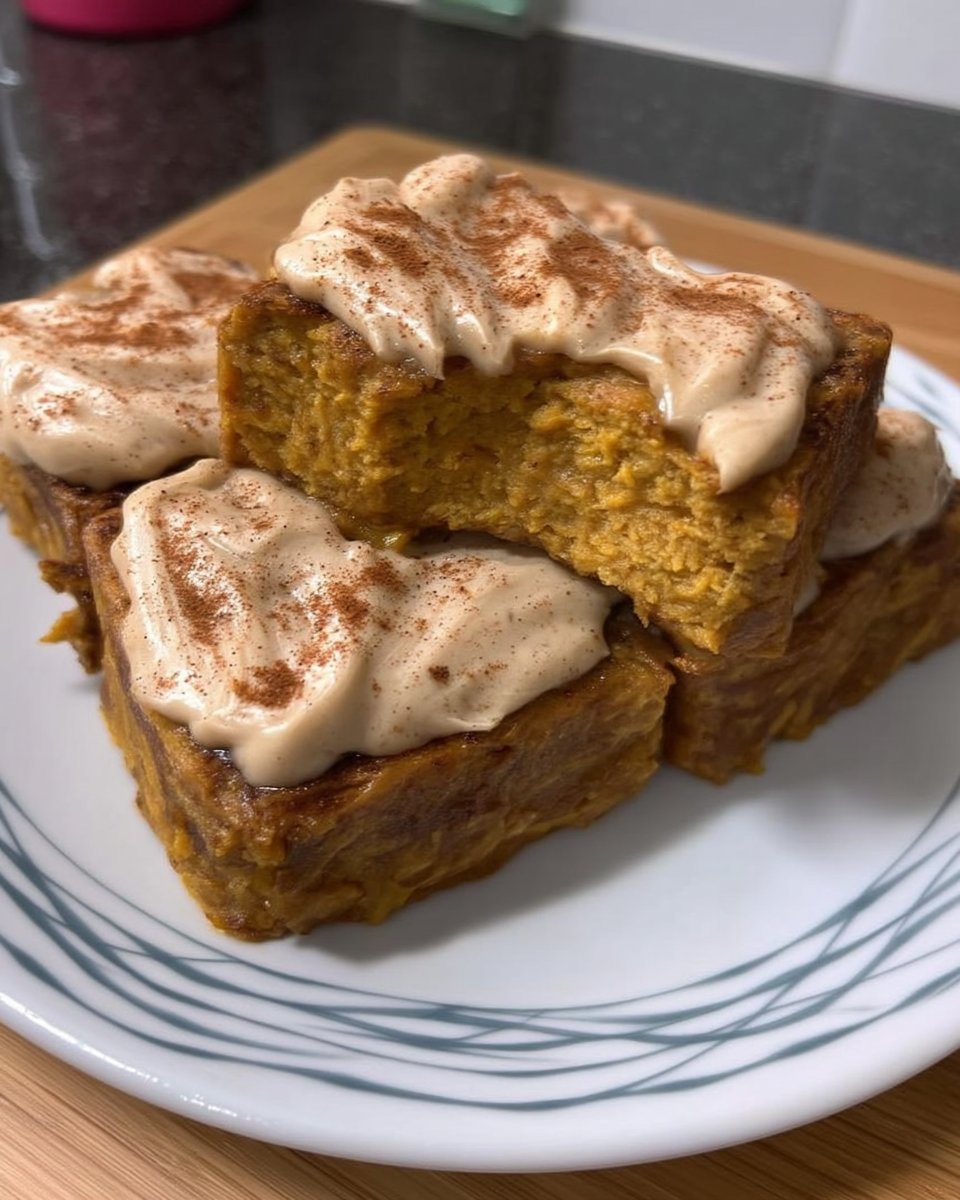 Bowl of pumpkin puree surrounded by cinnamon and nutmeg spices
