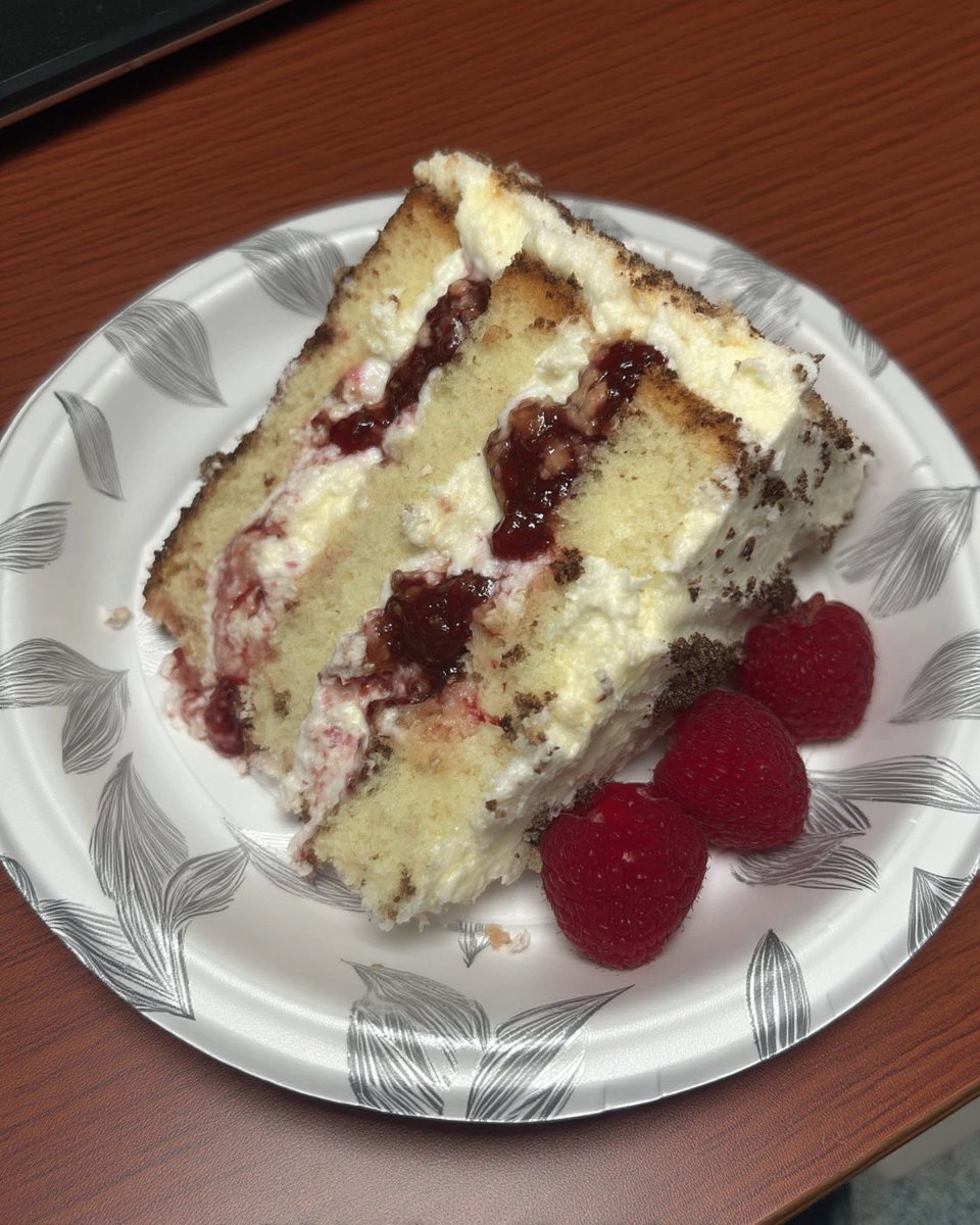 Whole raspberry white chocolate cake decorated with fresh berries