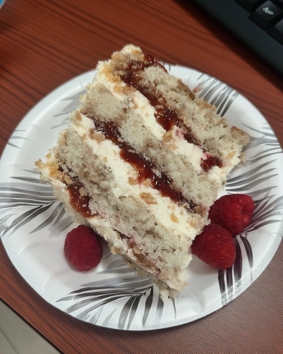 Slice of raspberry white chocolate cake with moist crumb and whipped ganache