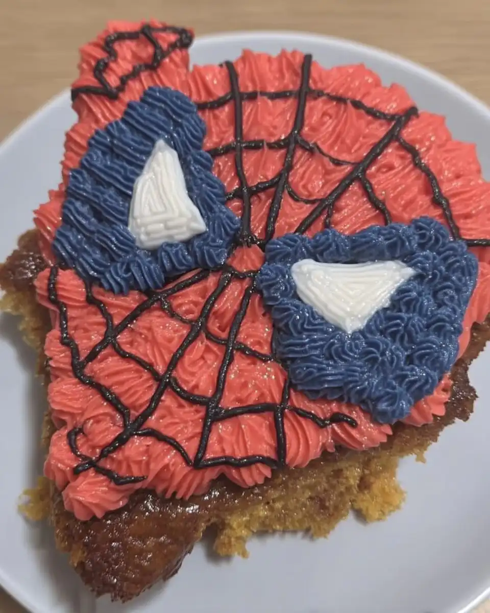 Spider Man Cake 13 Hands rolling thin strings of black fondant for cake decoration