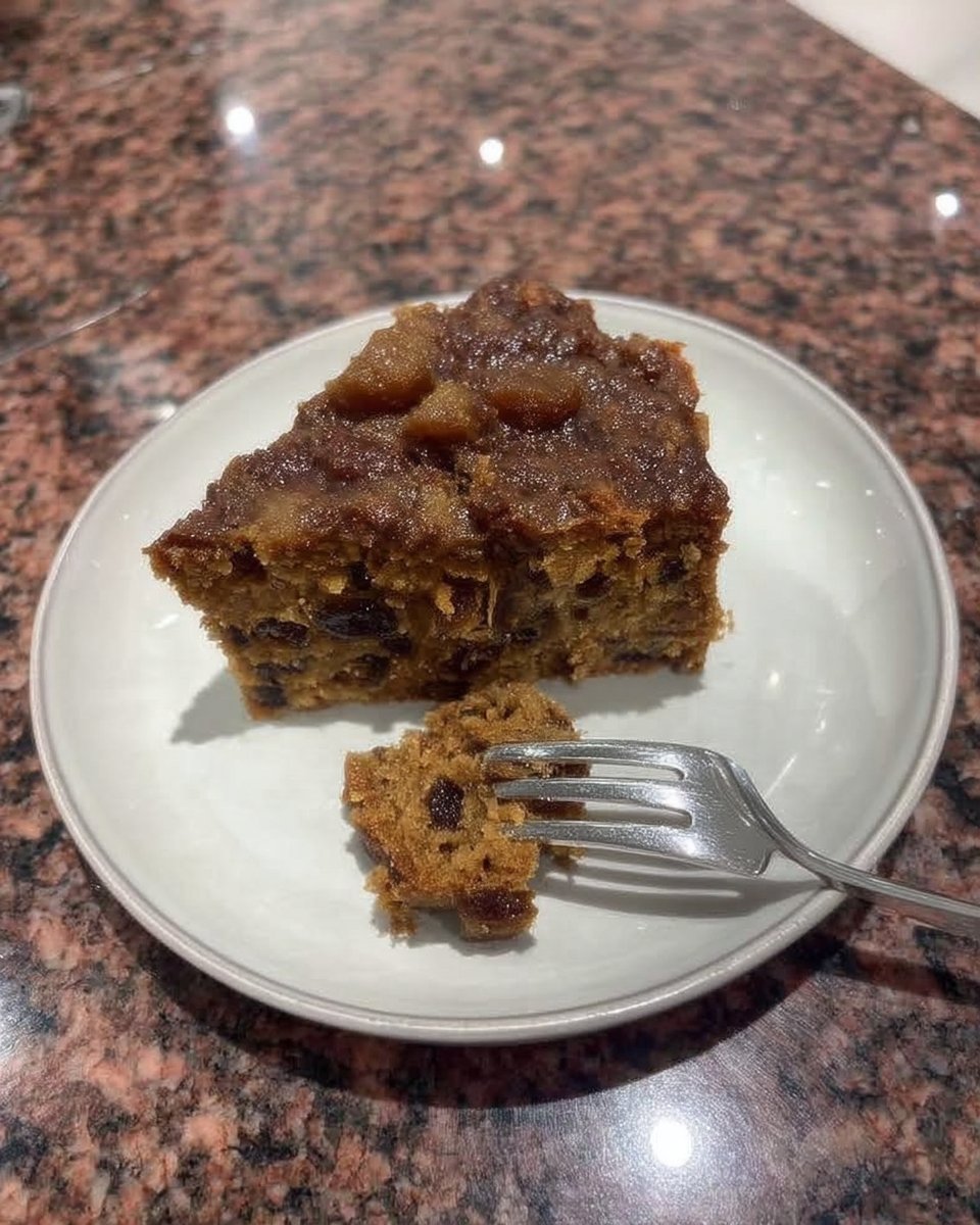 Thin slice of fruitcake served with a cup of black coffee