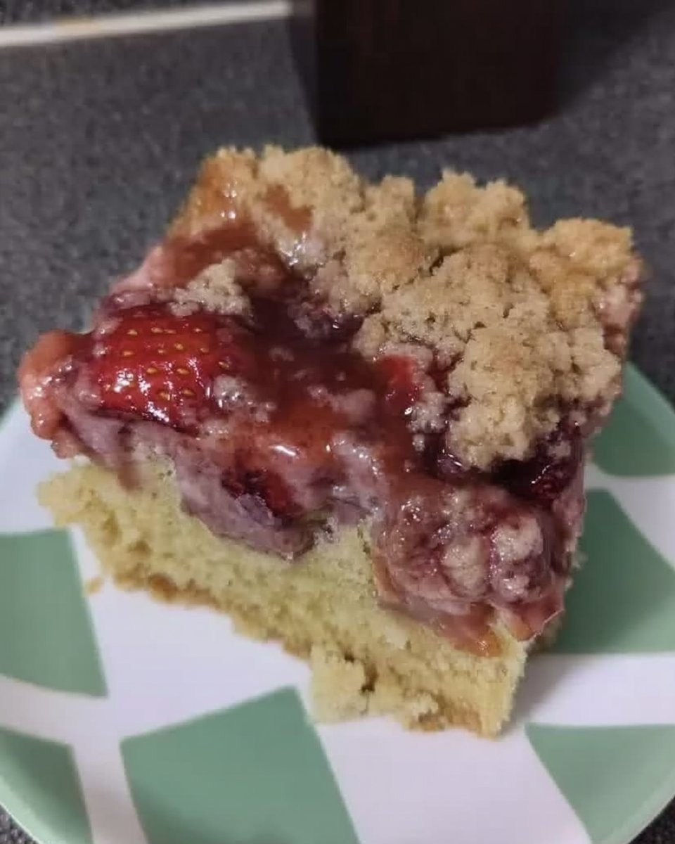Slice of moist strawberry rhubarb cake on ceramic plate