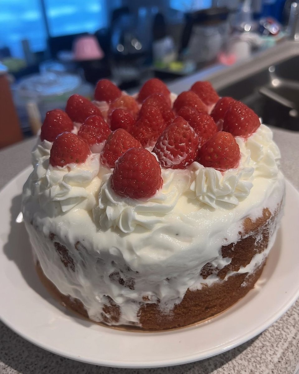 Slice of white almond sour cream cake on a plate with fork