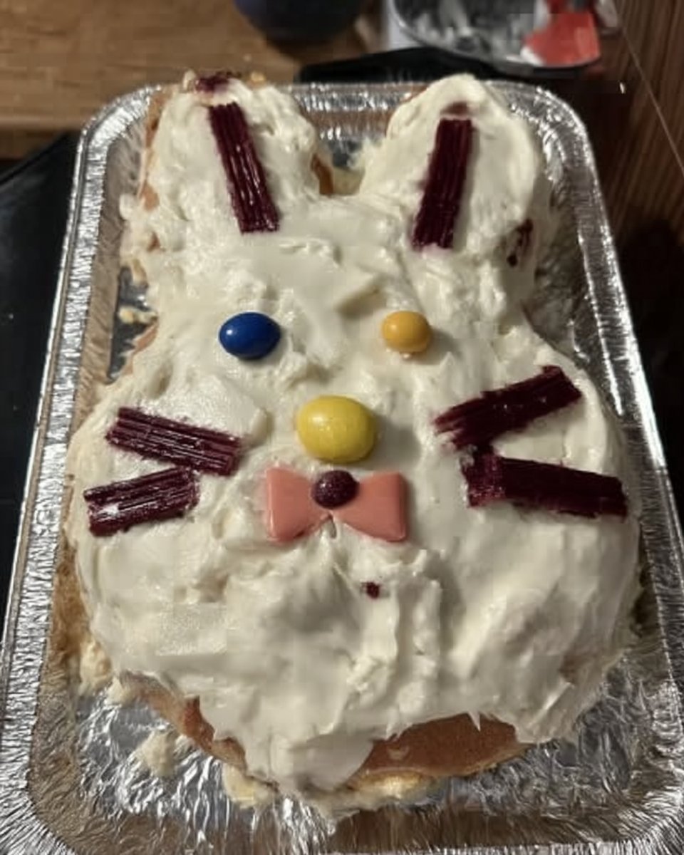 Speckled blue easter cake with toasted coconut nest and candy eggs