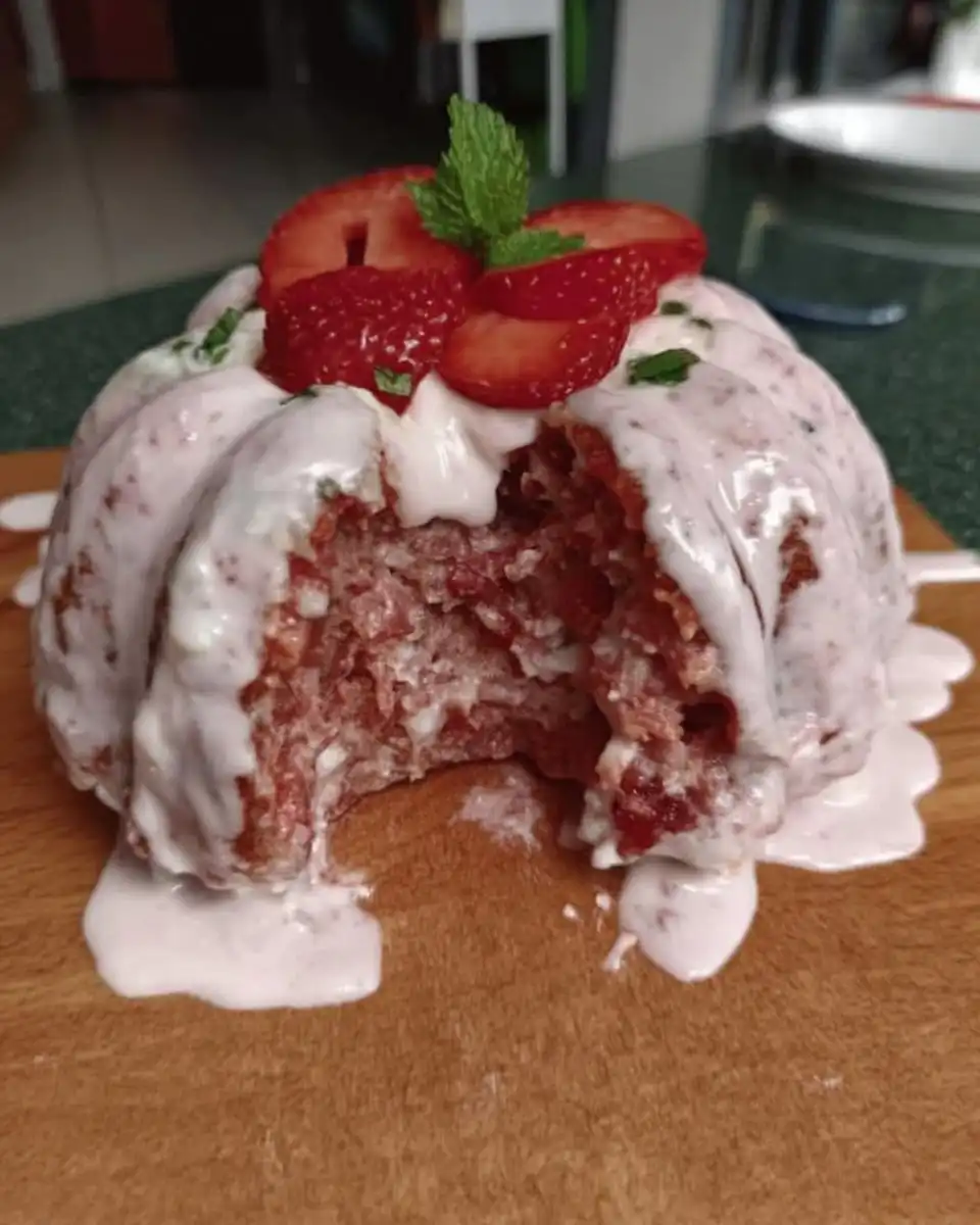 Pink strawberry cake batter being mixed in a bowl