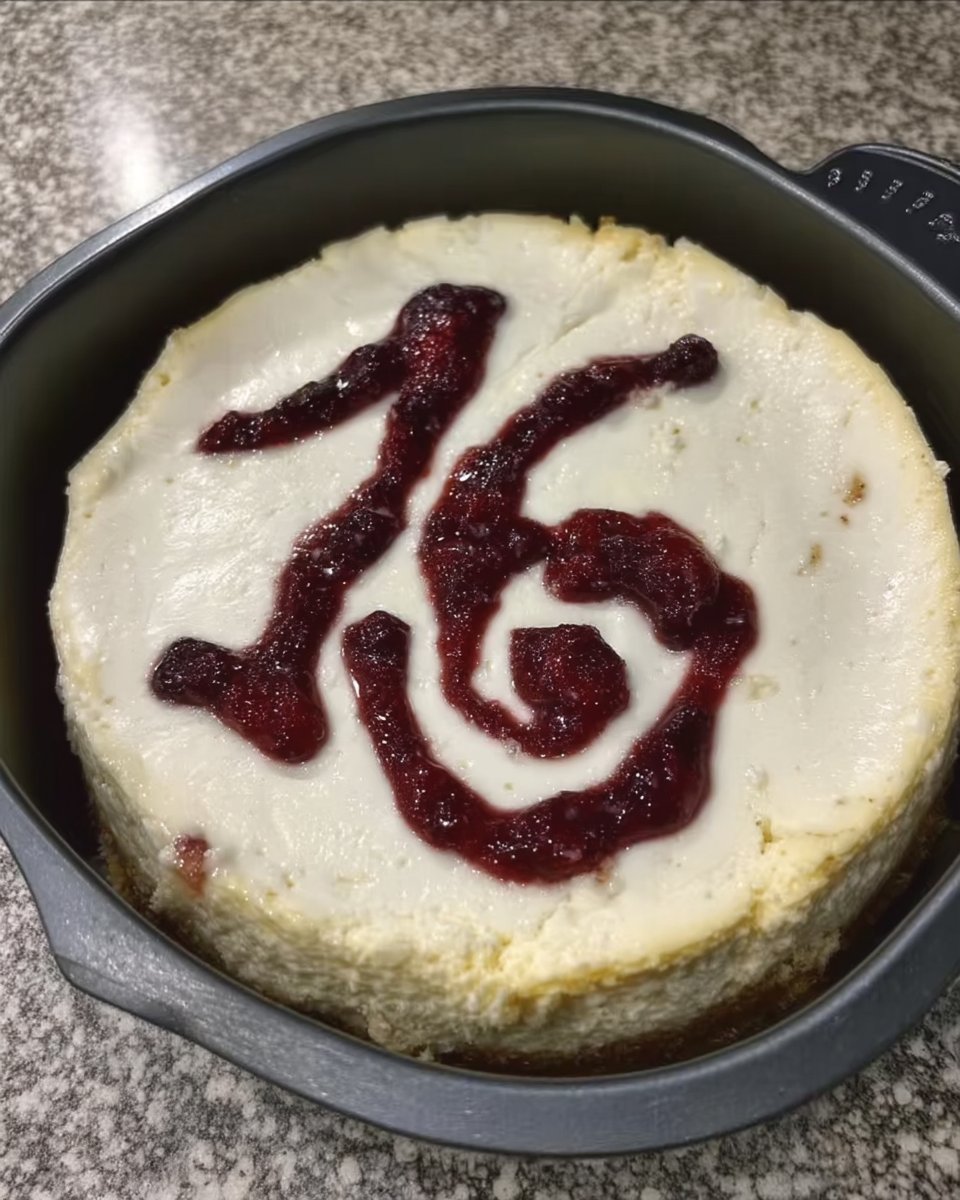 Cheesecake cooling in an oven with the door slightly ajar