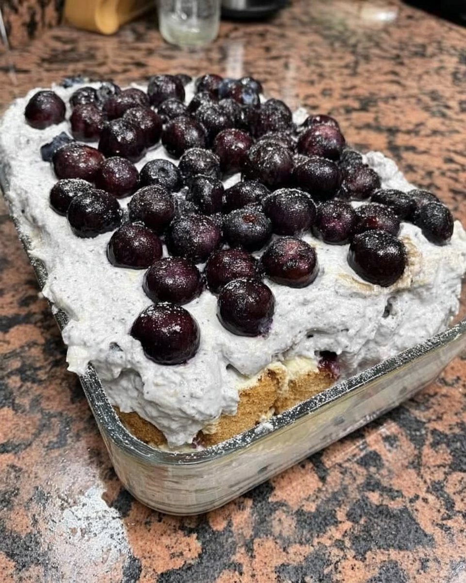 Slice of strawberry icebox cake showing layers of chocolate pudding cream and crackers