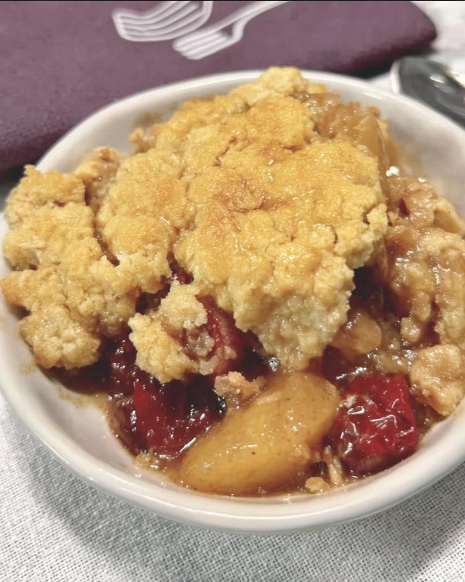 Warm apple cranberry dump cake topped with vanilla ice cream