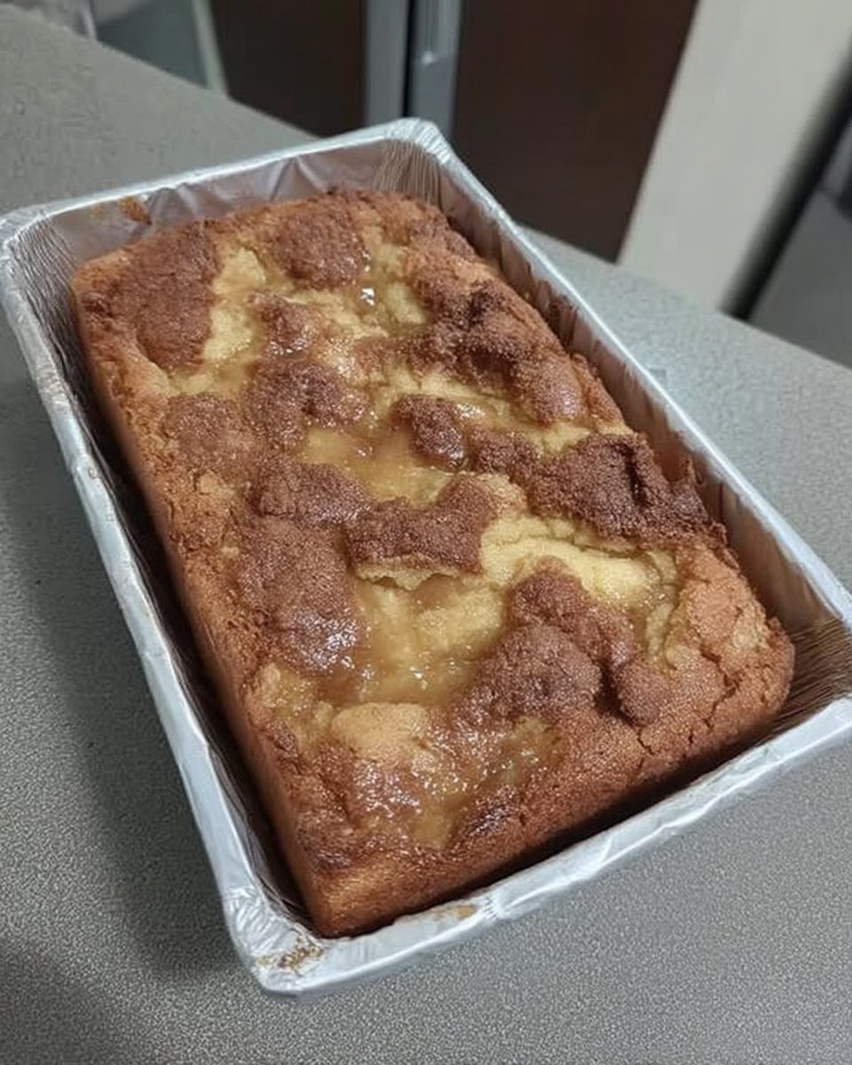 A square of ooey gooey butter cake on a white plate served next to a small cup of dark Turkish coffee.