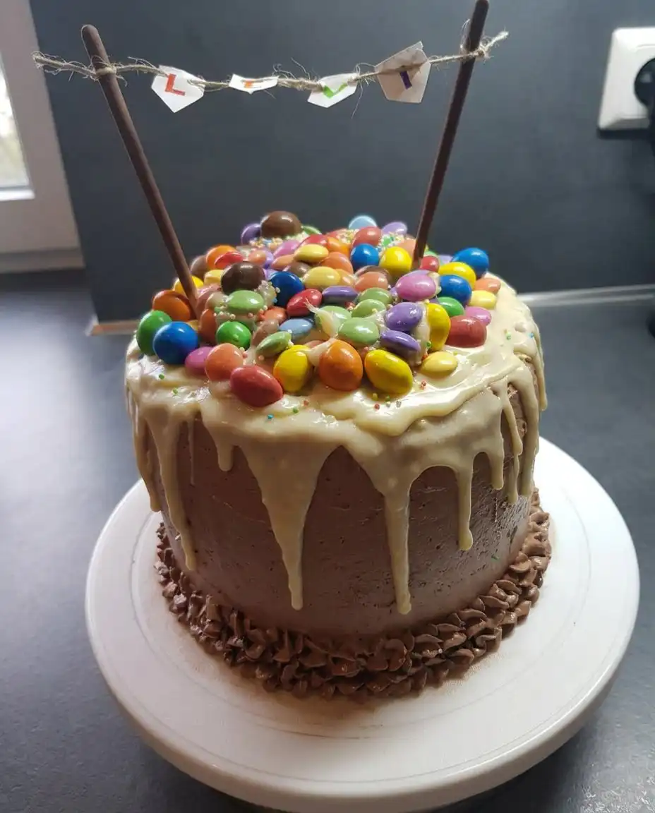 A slice of candy cake being removed to reveal the spilling candy center.