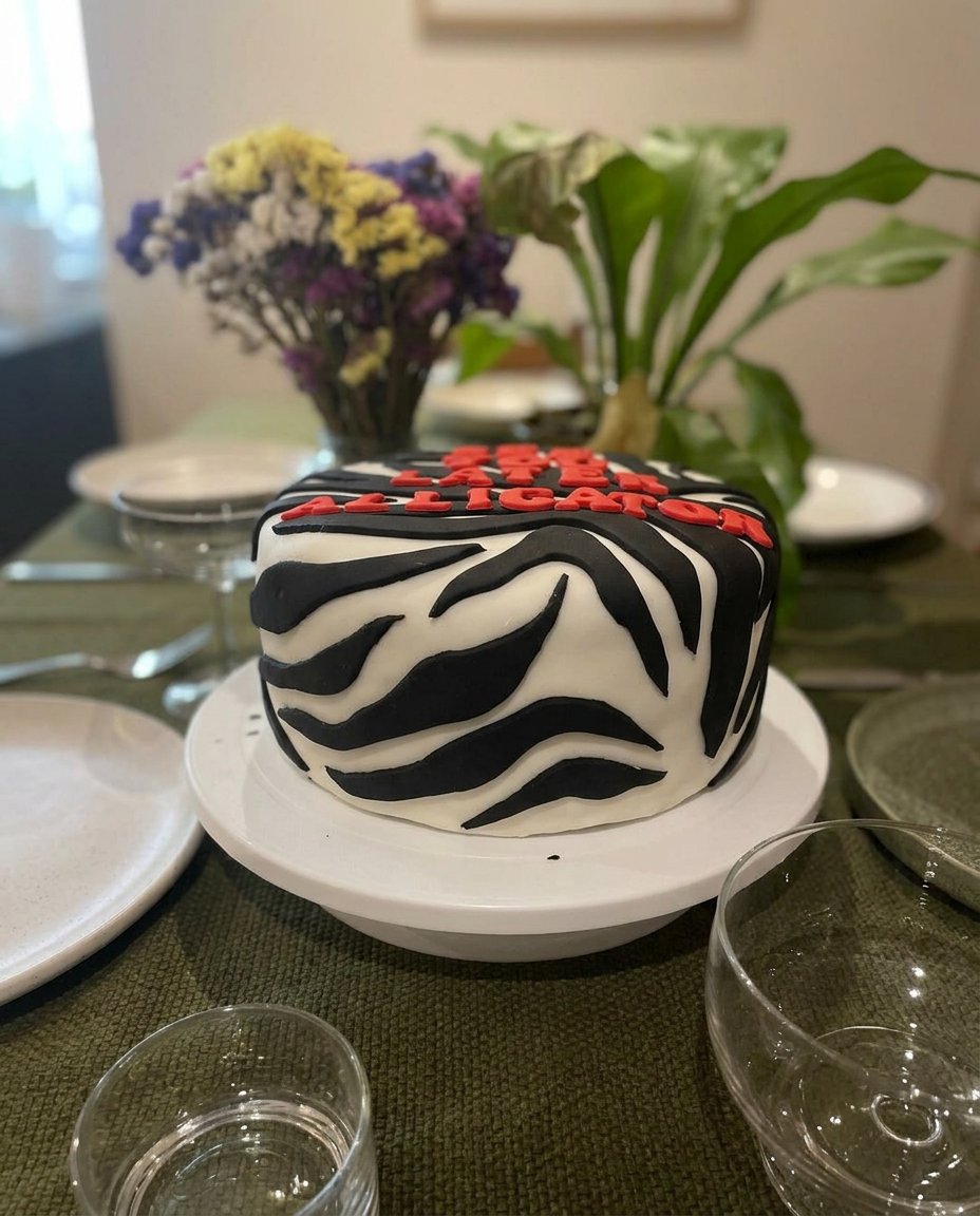 A close up of a hand inserting a toothpick into a yellow cake to check for crumbs
