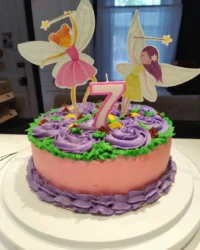 A beautiful pink ombre girl cake featuring a Barbie doll as the center of a rosette dress