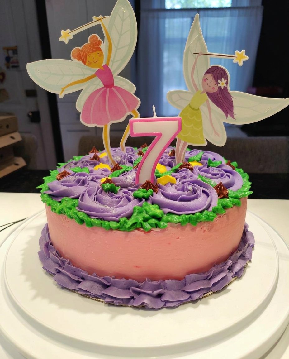 A beautiful pink ombre girl cake featuring a Barbie doll as the center of a rosette dress