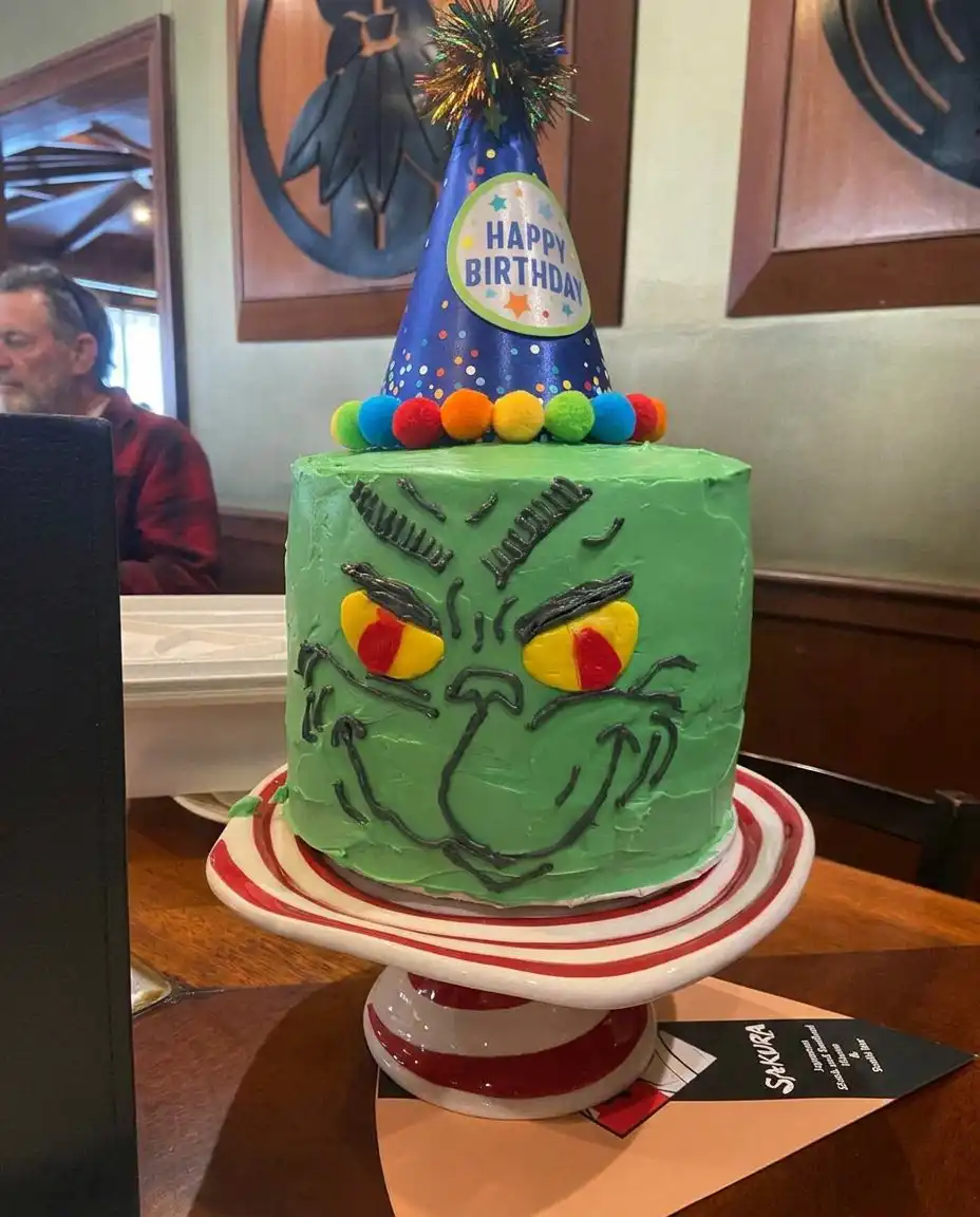 Grinch Cake 14 Multiple slices of Grinch Cake arranged on a platter with festive decorations.