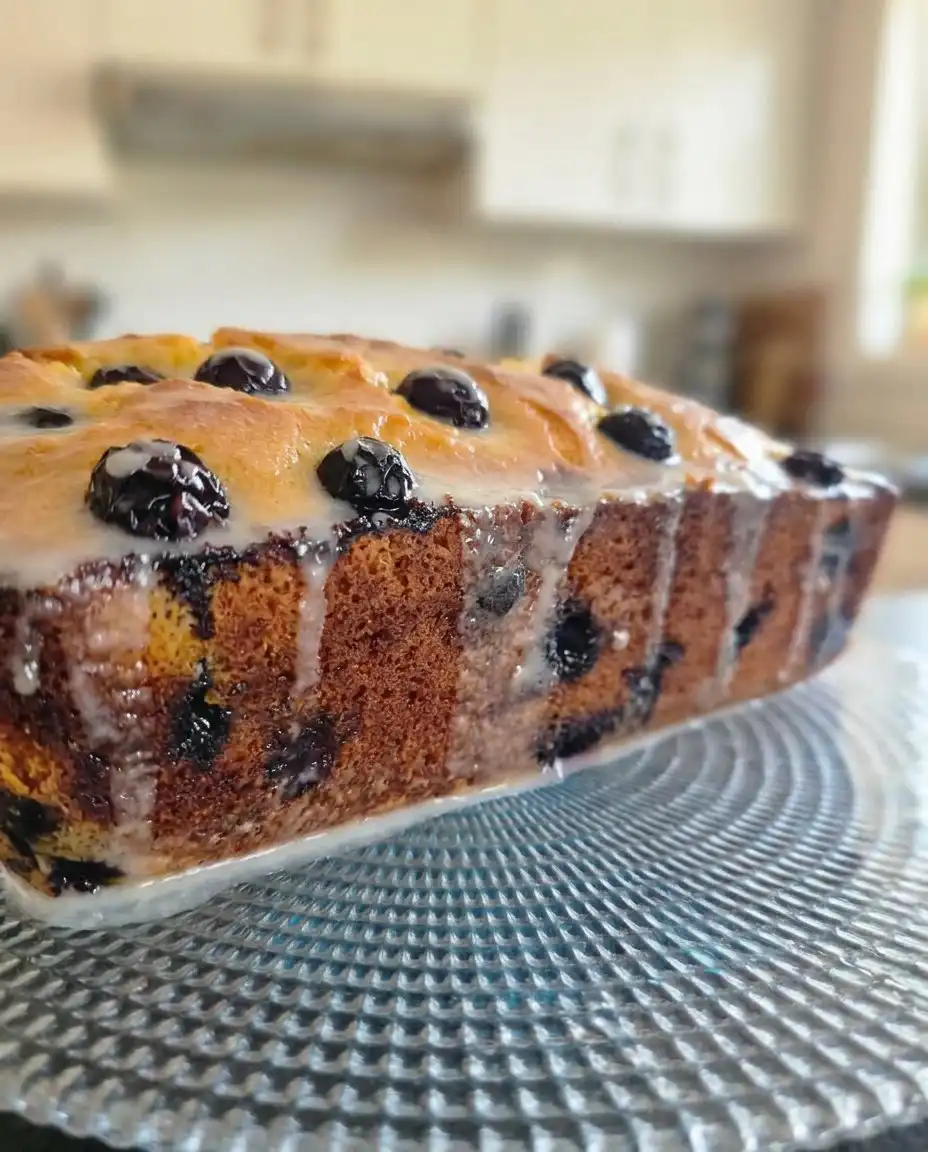Lemon Blueberry Cake 3 10 A close up shot showing the moist crumb and bursting blueberries of a lemon blueberry cake