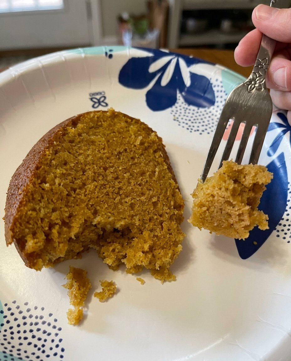 A hand whisking sweet potato mash with eggs and cream to form an emulsion