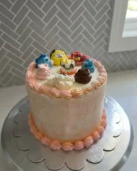 A moist Bts Cake with vanilla buttercream and purple sprinkles