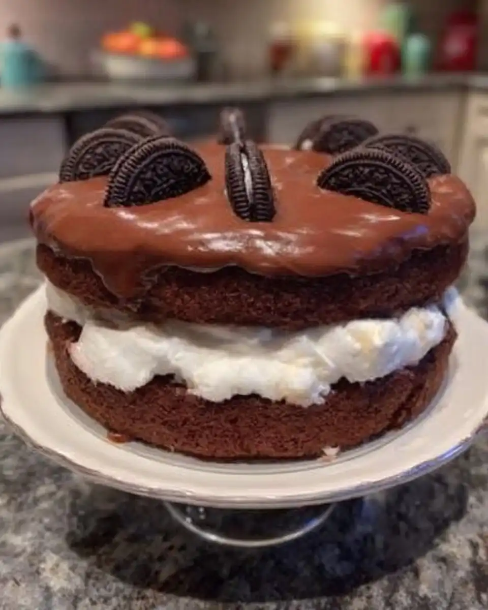 Oreo Cake 12 Ingredients for Oreo cake including flour, butter, and crushed cookies on a marble surface