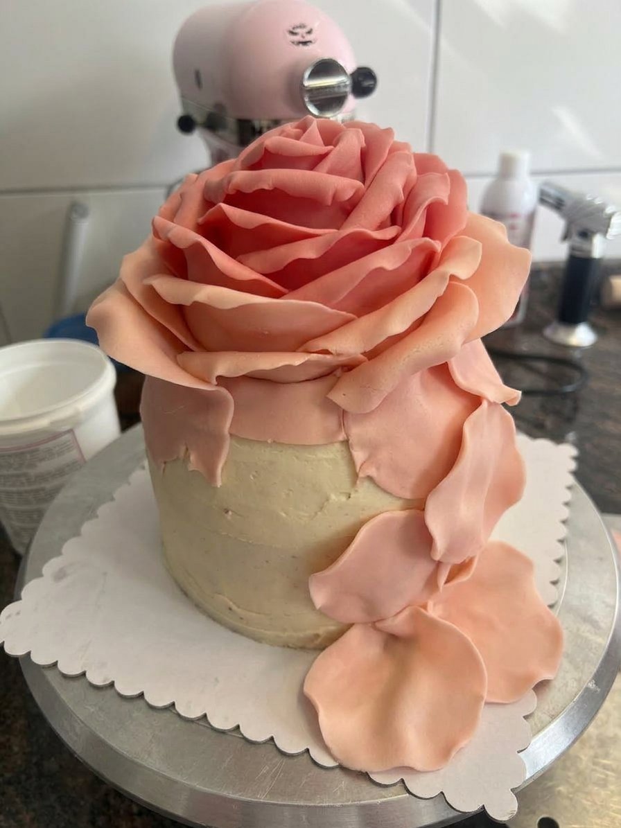 A slice of rose cake served next to a small cup of Turkish coffee