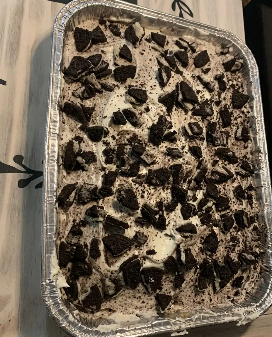 A clean wedge of cookie cake on a white plate with melted chocolate