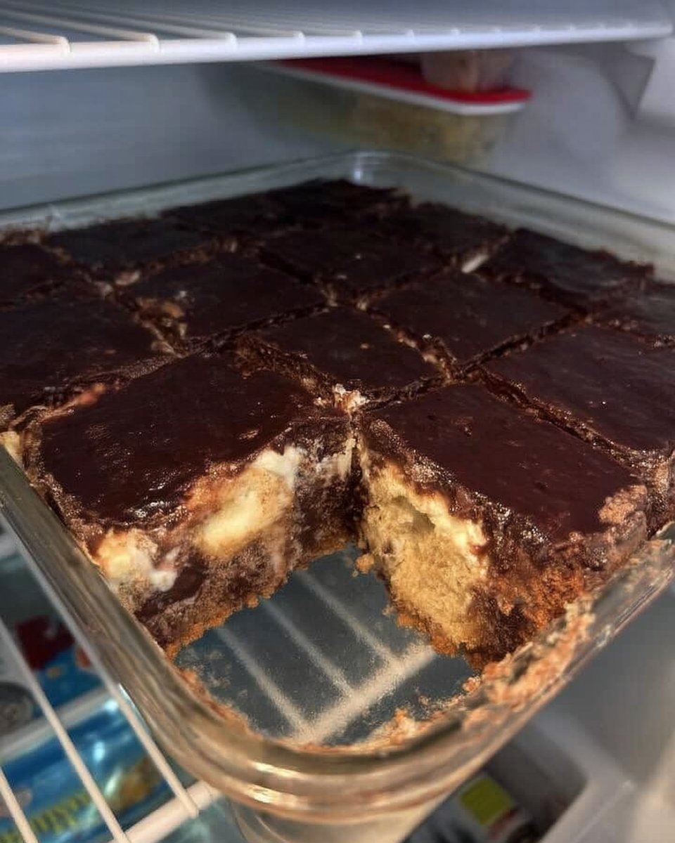 Chocolate Eclair Cake 14 A chilled slice of chocolate eclair cake on a white plate