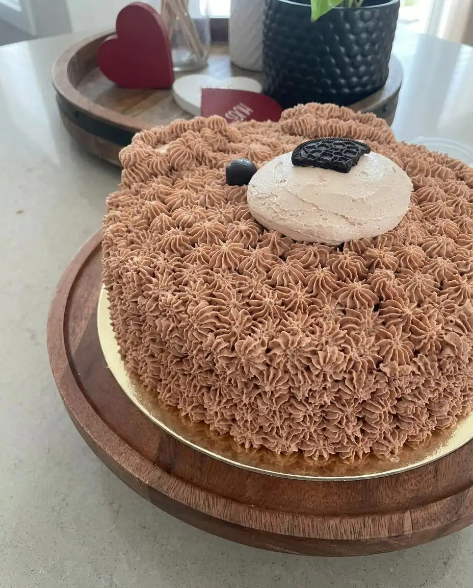 A slice of the chocolate bear cake showing the internal structure and thick fur frosting.