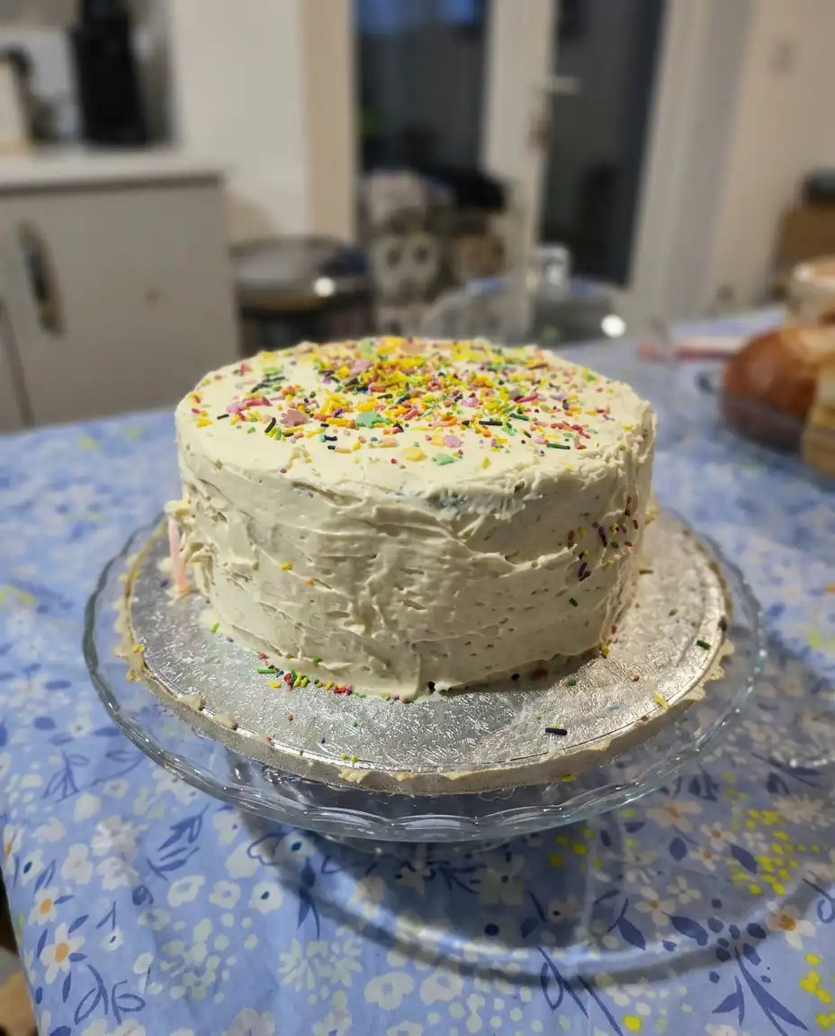 A clean slice of birthday cake showing even layers and smooth frosting.
