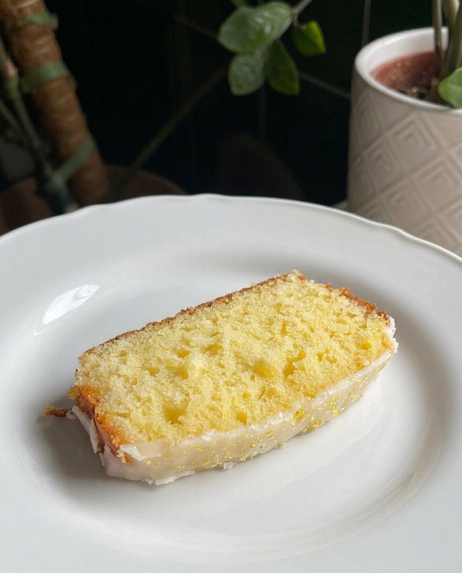 Glossy yellow lemon curd being stirred in a saucepan