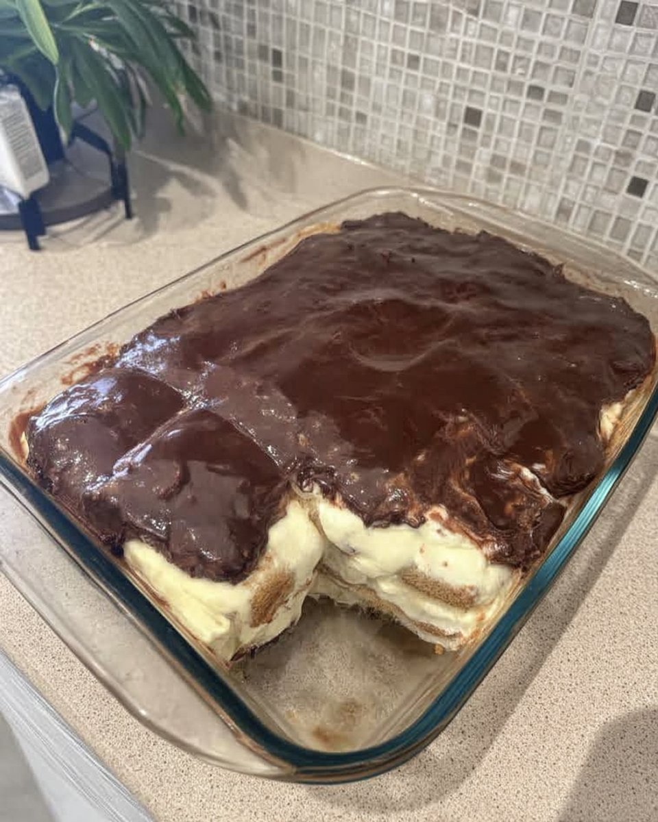 Chocolate Eclair Cake 13 Spreading warm chocolate frosting over the top of the eclair cake
