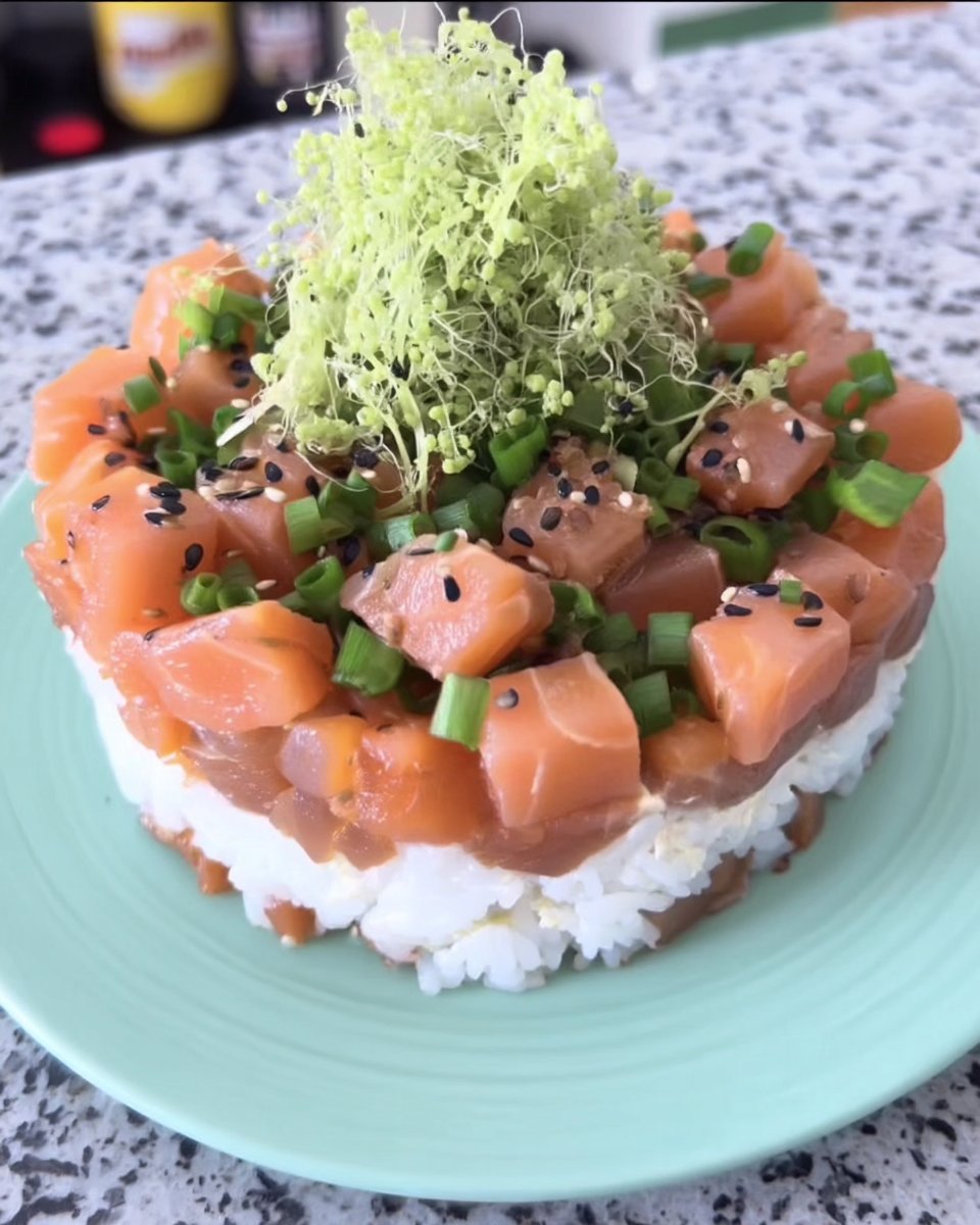 A beautifully layered sushi cake with salmon avocado and cream cheese