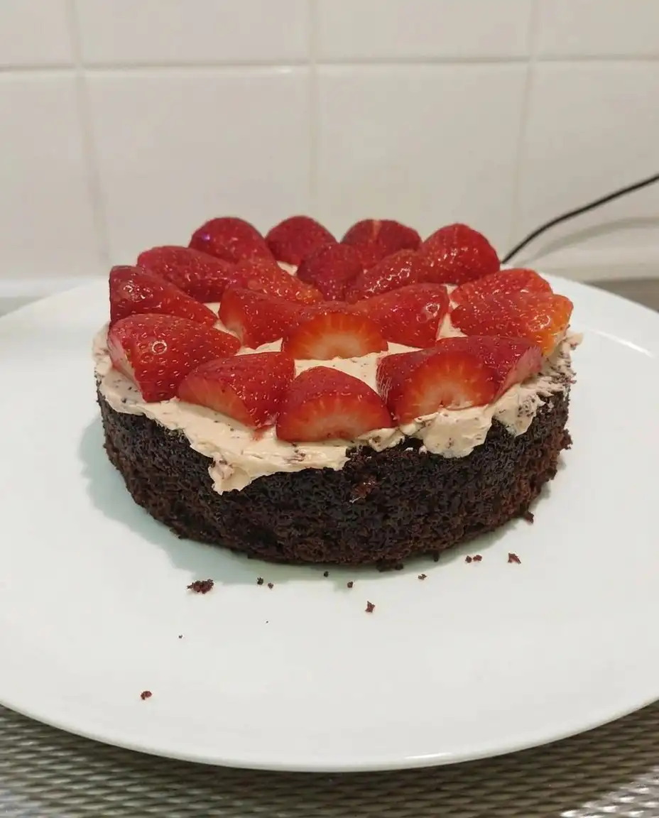 Strawberry Chocolate Cake 13 Pink strawberry buttercream in a glass bowl being whipped with a whisk