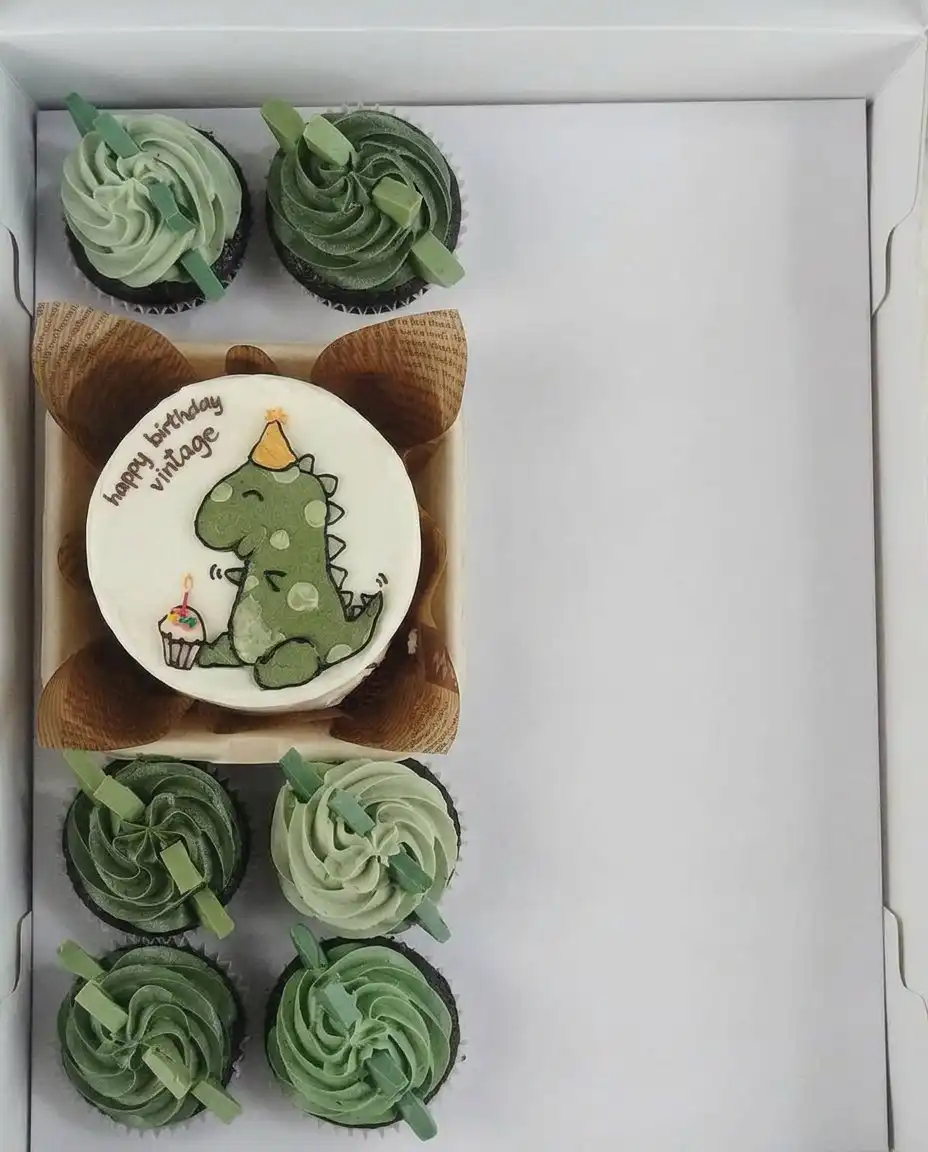 A bento cake in a small box next to a cup of coffee