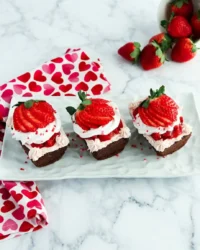 A close up of a chocolate strawberry cake with a ruby red glaze soaking into the sponge.