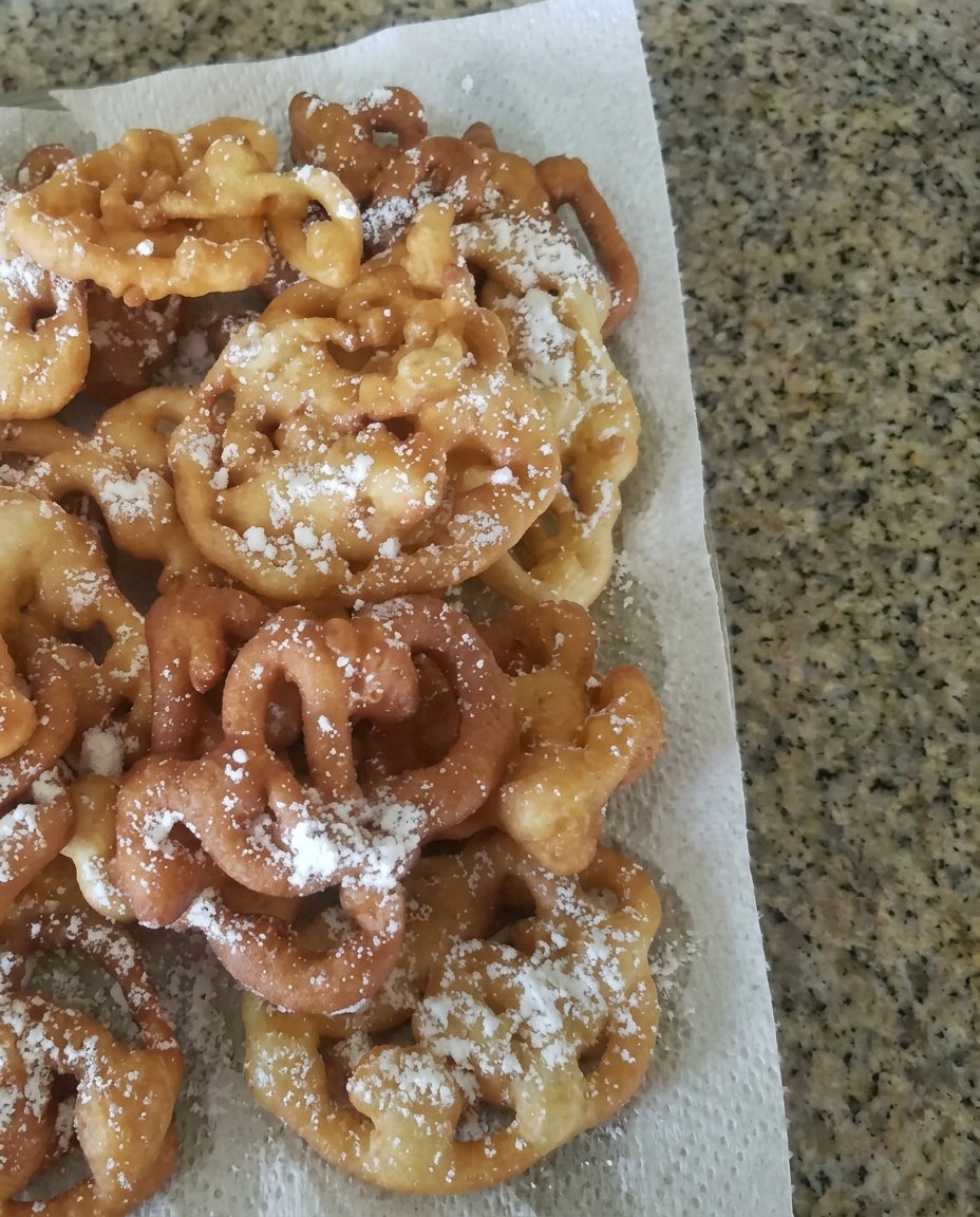 Bowls containing flour, milk, eggs and sugar for funnel cake batter