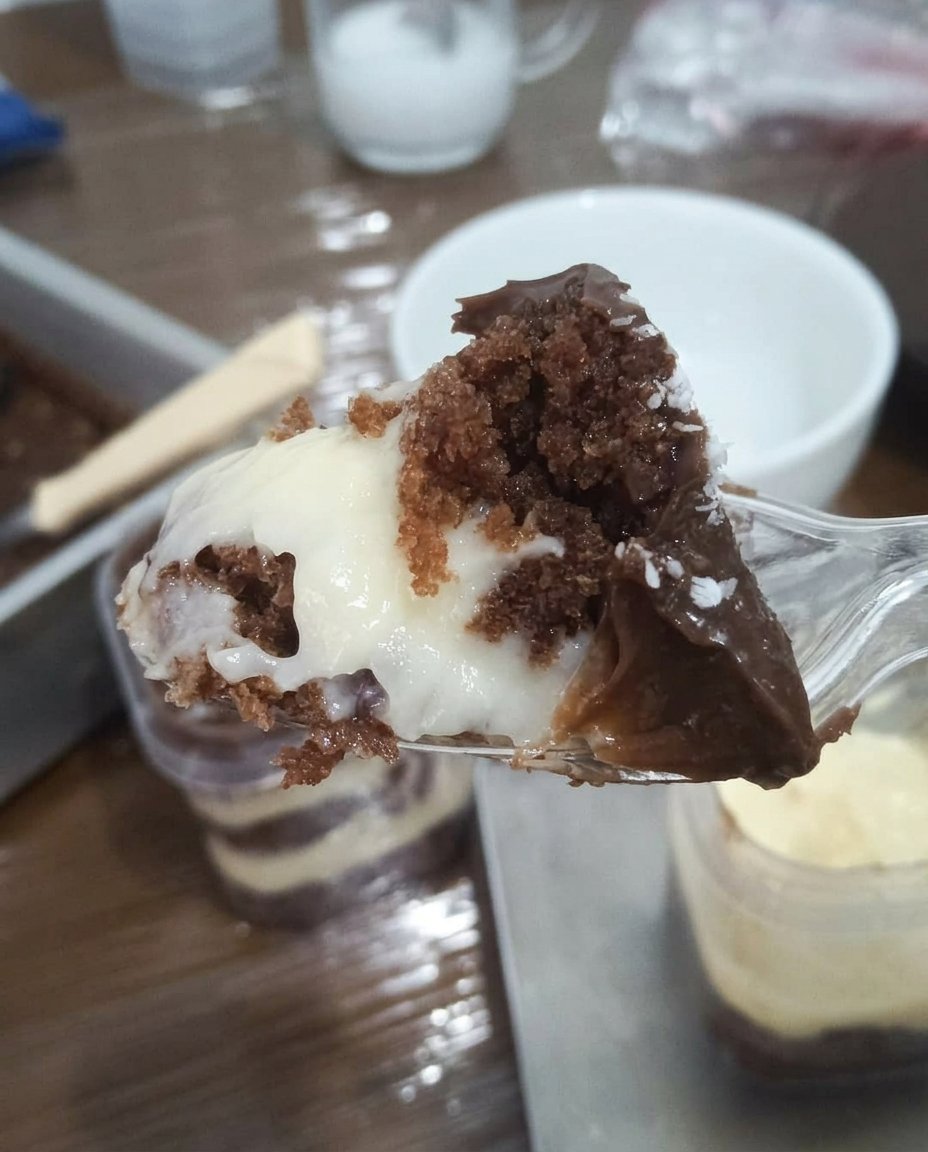 Jar Cake 13 A pastry bag piping a precise layer of buttercream into a glass jar